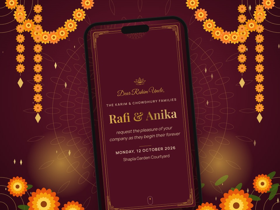 A royal maroon and gold wedding invitation on a phone, framed by marigold garlands